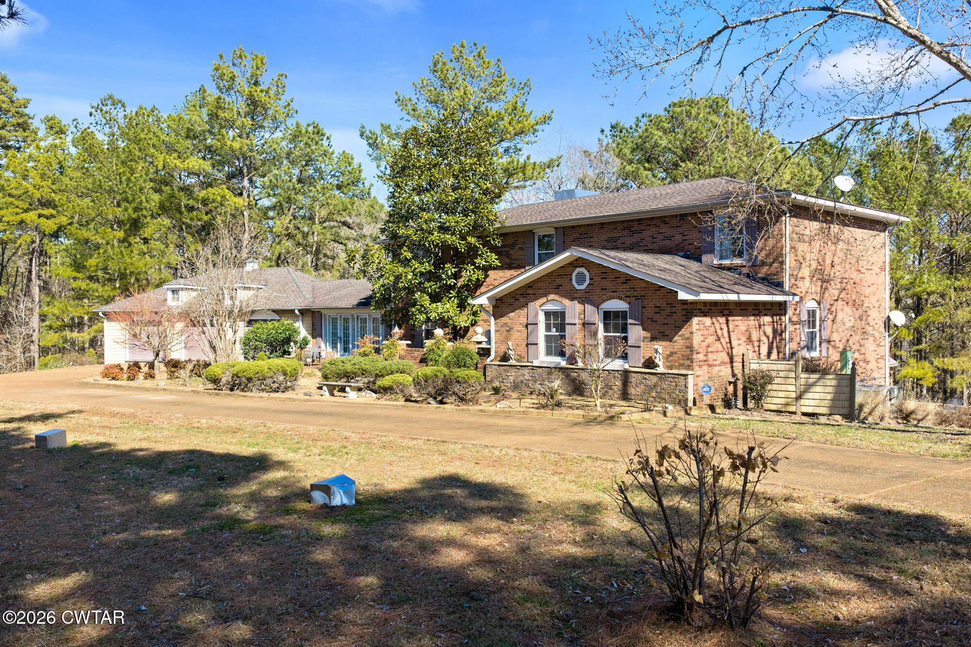 260 Myracle Town Road Parsons, TN 38363 - Photo 2 of 36 a front view of a house with a yard and garage