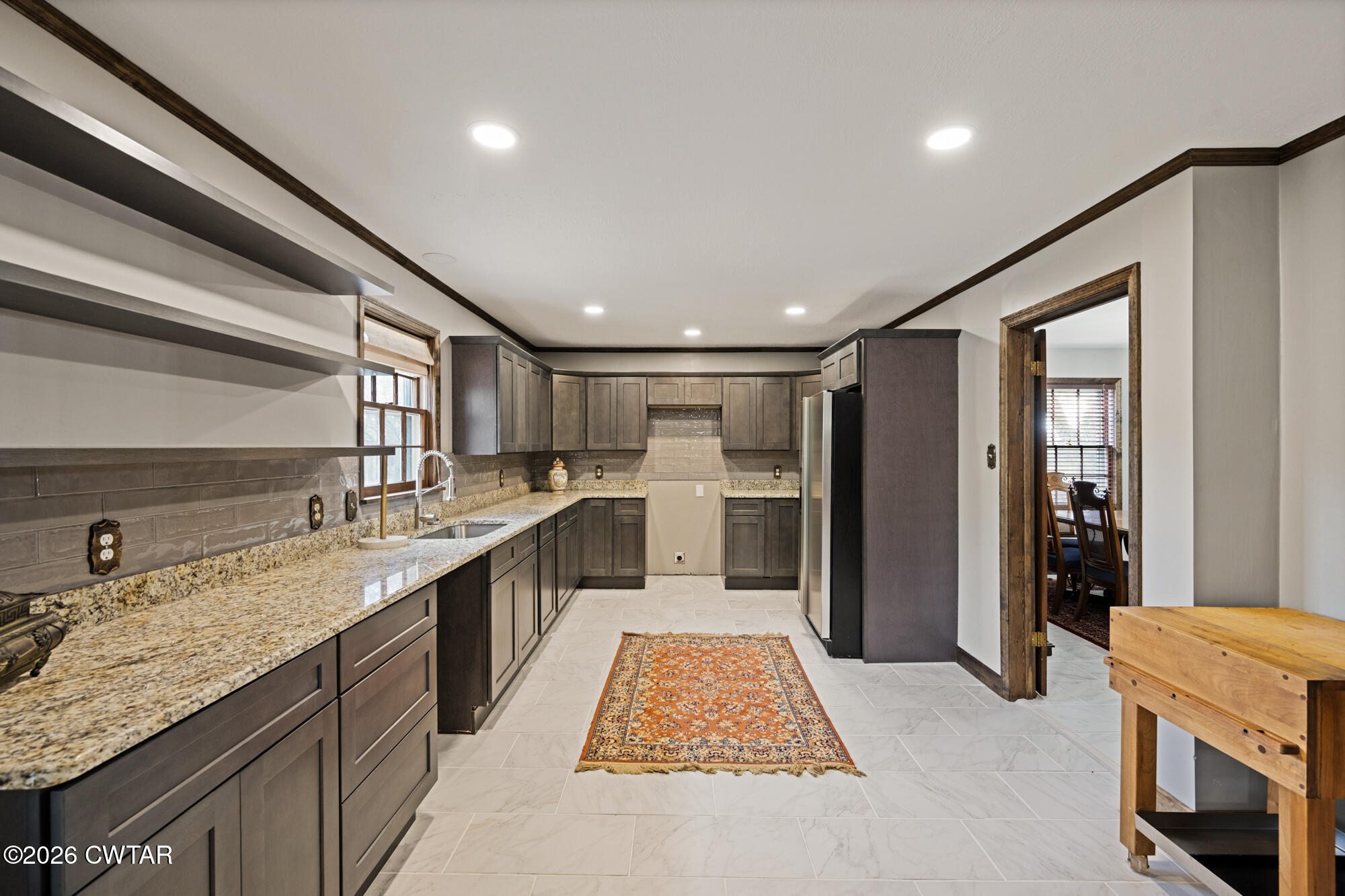 260 Myracle Town Road Parsons, TN 38363 - Photo 22 of 36 a large kitchen with stainless steel appliances granite countertop plenty wooden cabinets counter space and a sink