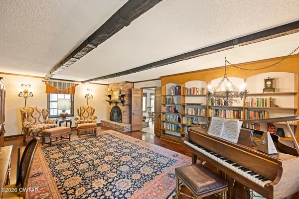 a living room with furniture fireplace and flat screen tv