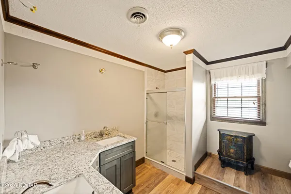 a bedroom with a bed chair and a window