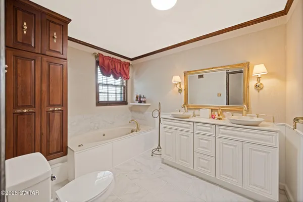 a bedroom with two beds and a large window