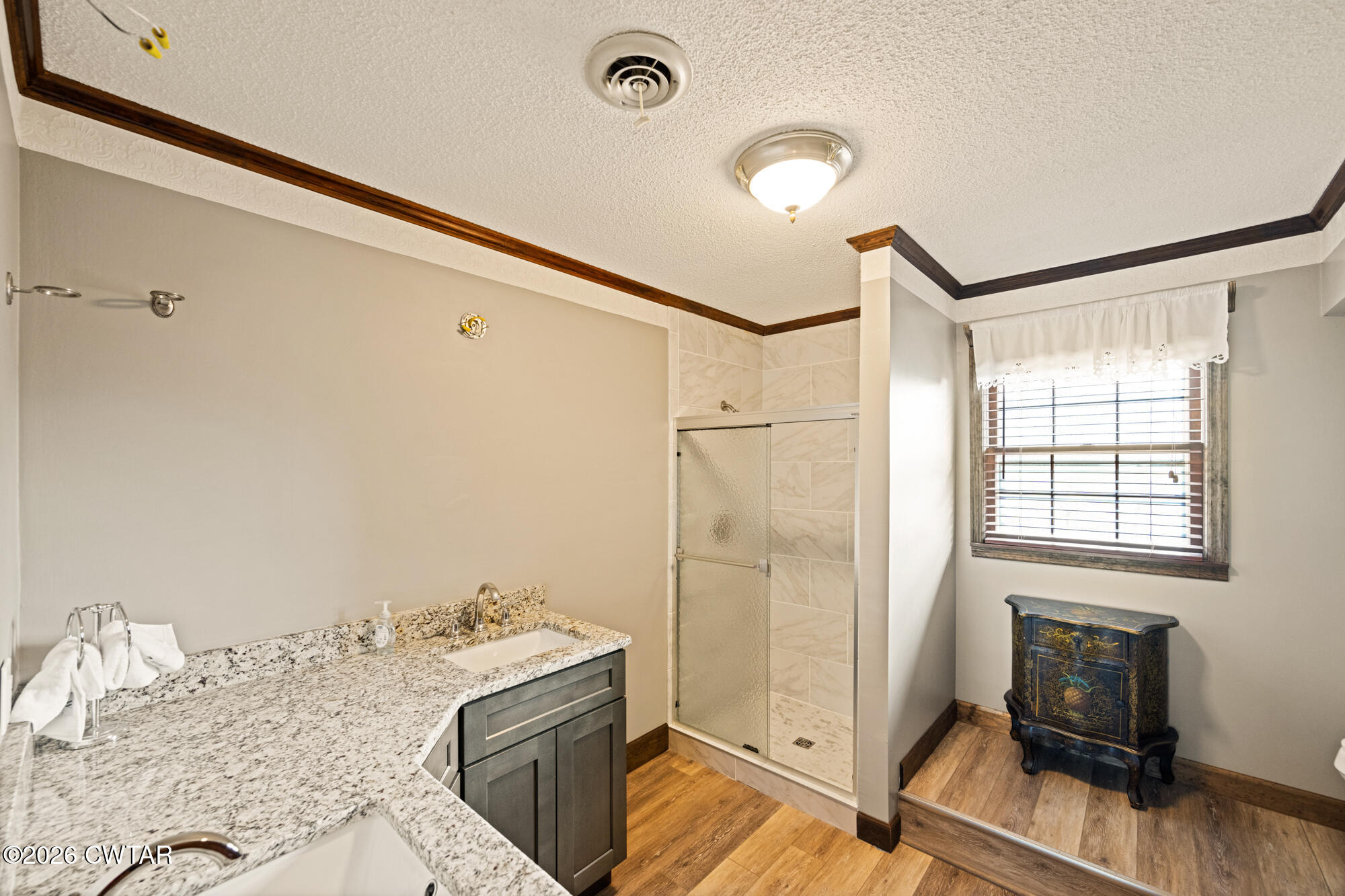 260 Myracle Town Road Parsons, TN 38363 - Photo 33 of 41 a bathroom with a granite countertop sink toilet and shower