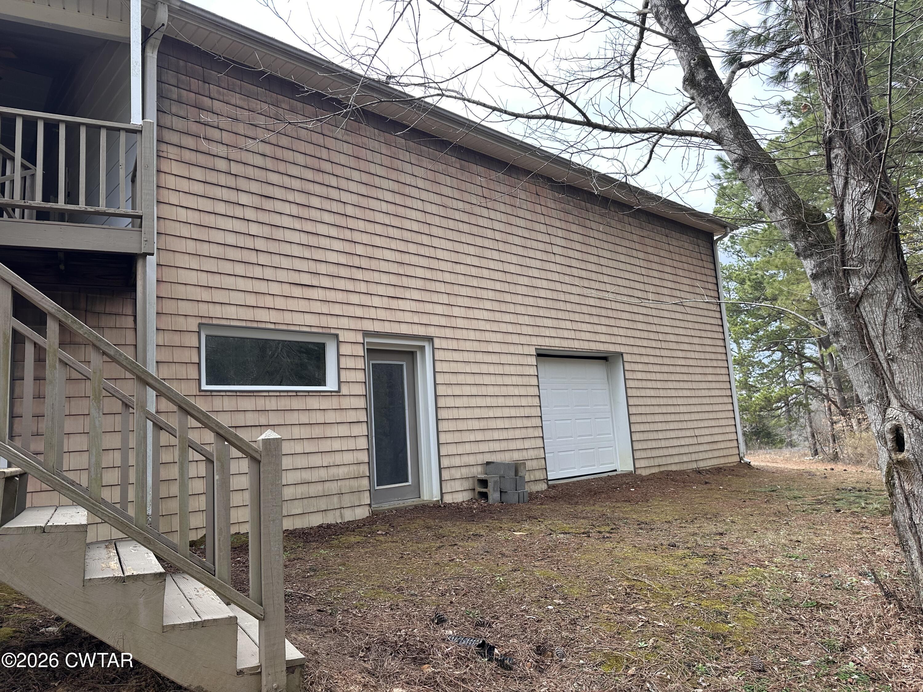 260 Myracle Town Road Parsons, TN 38363 - Photo 36 of 36 a view of a house with a yard and garage