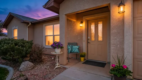 a kitchen with stainless steel appliances granite countertop a refrigerator a stove and a sink with wooden cabinets
