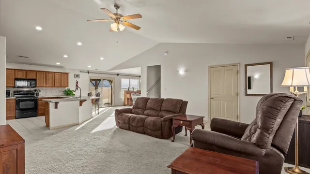 a living room with furniture kitchen and a stove
