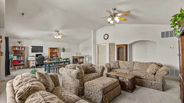 a living room with furniture and chandelier