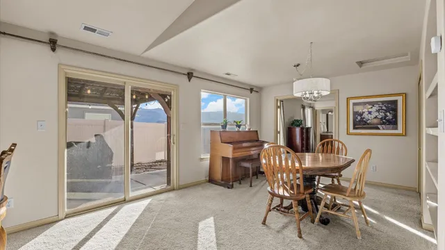 a dining room with furniture and window