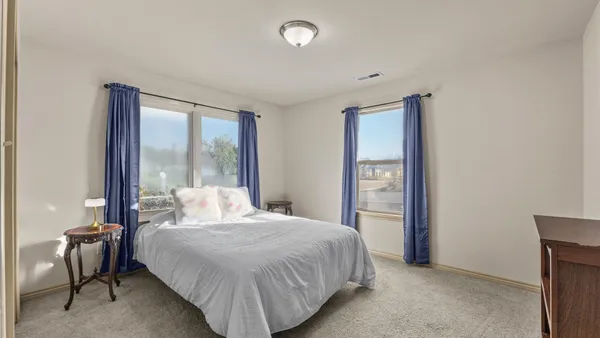 a bedroom with a large bed and a chandelier