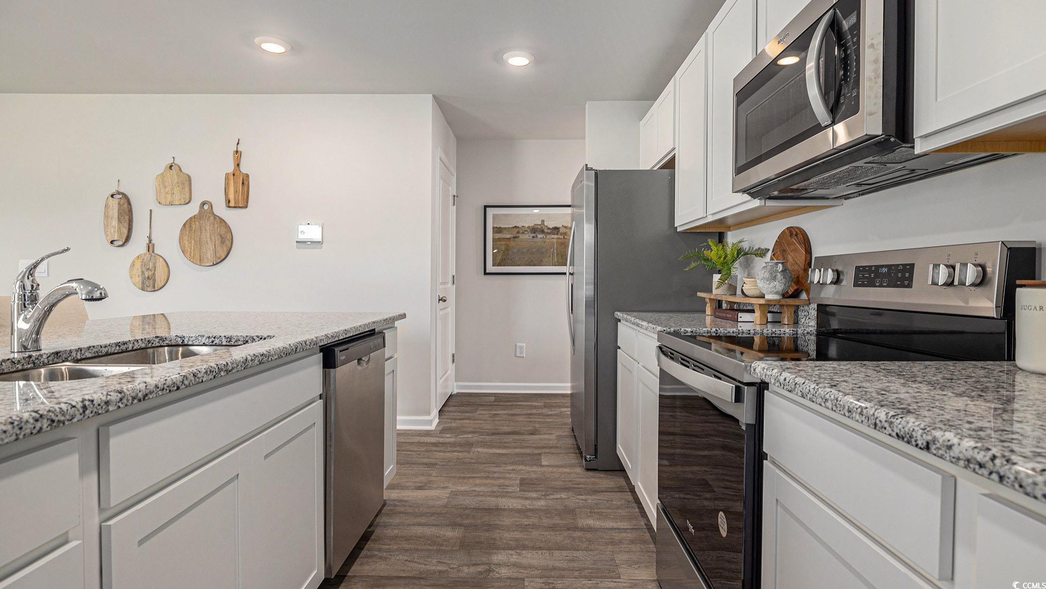 117 Homestead Way Myrtle Beach, SC 29588 - Photo 5 of 23 Kitchen featuring stainless steel appliances, white cabinets, light stone counters, recessed lighting, and dark wood finished floors