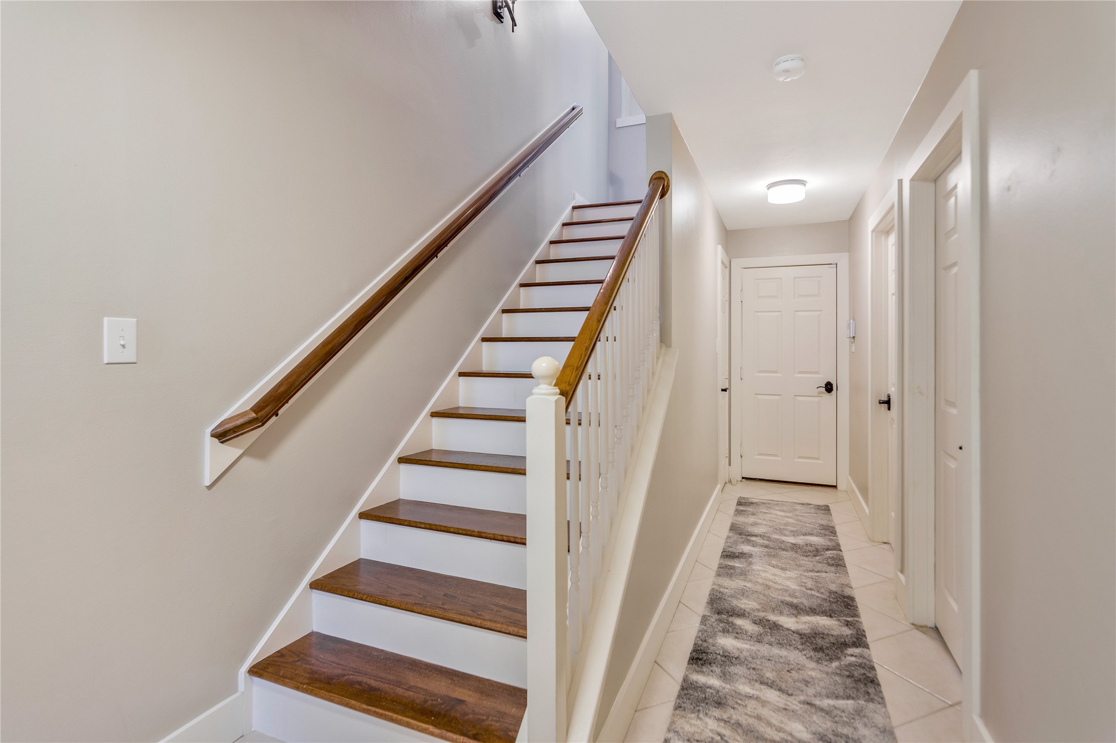 1207 Nagle Street Houston, TX 77003 - Photo 4 of 26 Greeted by a beautiful wood stairwell leading to the second floor. The entry also leads you to the downstairs bedroom and full bath.