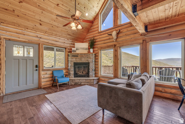 2348 North Miles Holw Road, Unit 26 Kamas, UT 84036 - Photo 6 of 31 Living room featuring hardwood / wood-style floors, log walls, a fireplace, a ceiling fan, and a vaulted wood ceiling