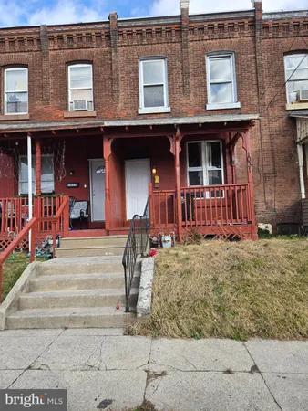 front view of a brick house with a small yard
