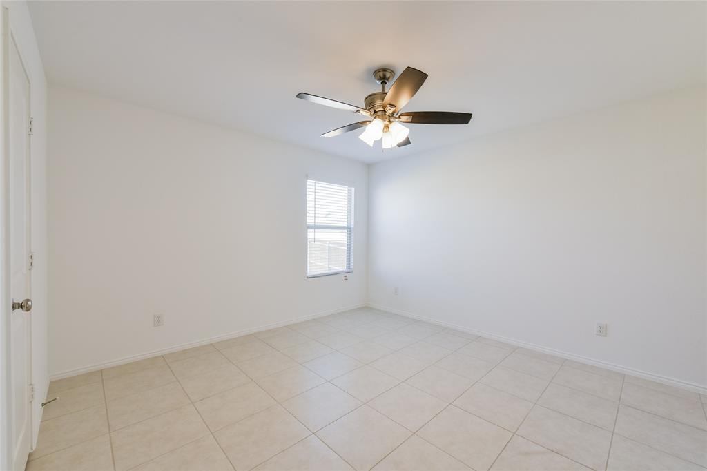 340 Dry Cyn Way Haslet, TX 76052 - Photo 6 of 15 an empty room with a window and a fan