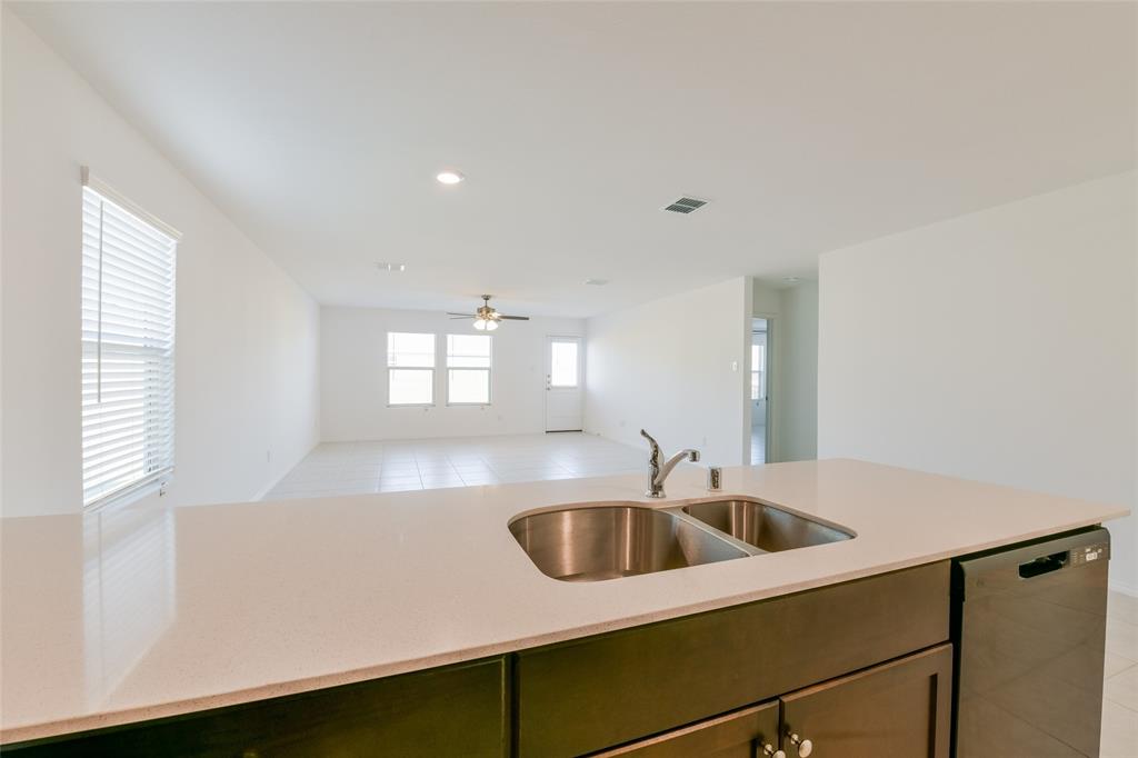 340 Dry Cyn Way Haslet, TX 76052 - Photo 7 of 15 a kitchen with sink cabinets and window