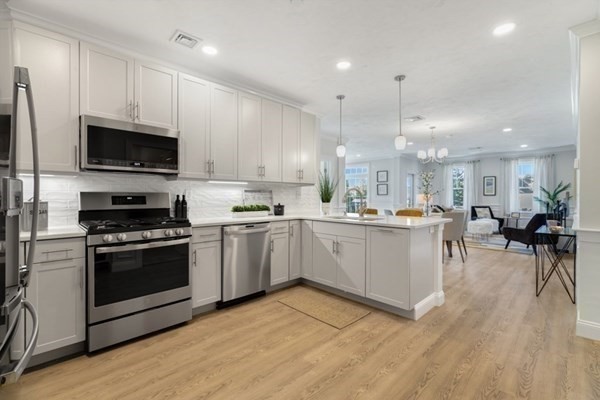 320 Middlesex Avenue, Unit B110 Medford, MA 02155 - Photo 2 of 19 a kitchen with white cabinets and appliances