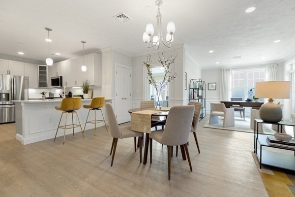 320 Middlesex Avenue, Unit B110 Medford, MA 02155 - Photo 5 of 19 a view of a dining room with furniture and wooden floor