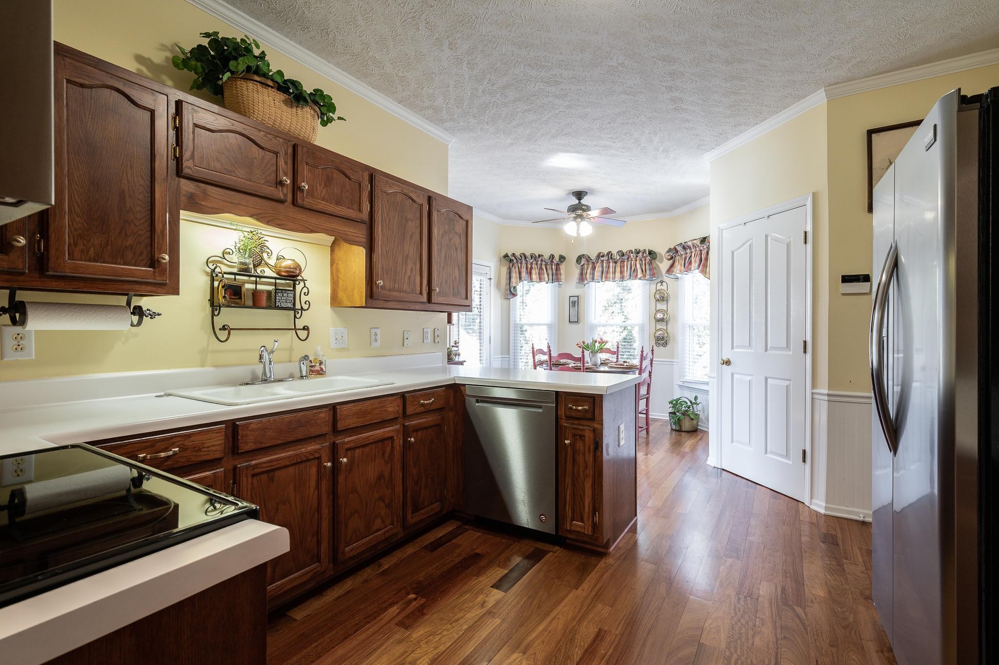 2407 Taylor Close Murfreesboro, TN 37130 - Photo 16 of 42 a kitchen with stainless steel appliances granite countertop a refrigerator a sink dishwasher a stove and white countertops with wooden floor