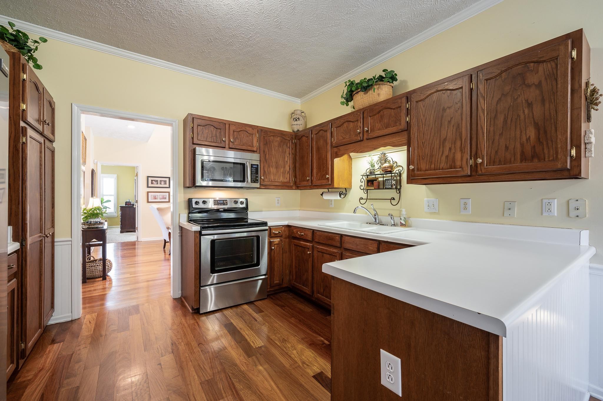 2407 Taylor Close Murfreesboro, TN 37130 - Photo 17 of 42 a kitchen with granite countertop a stove a sink and a microwave