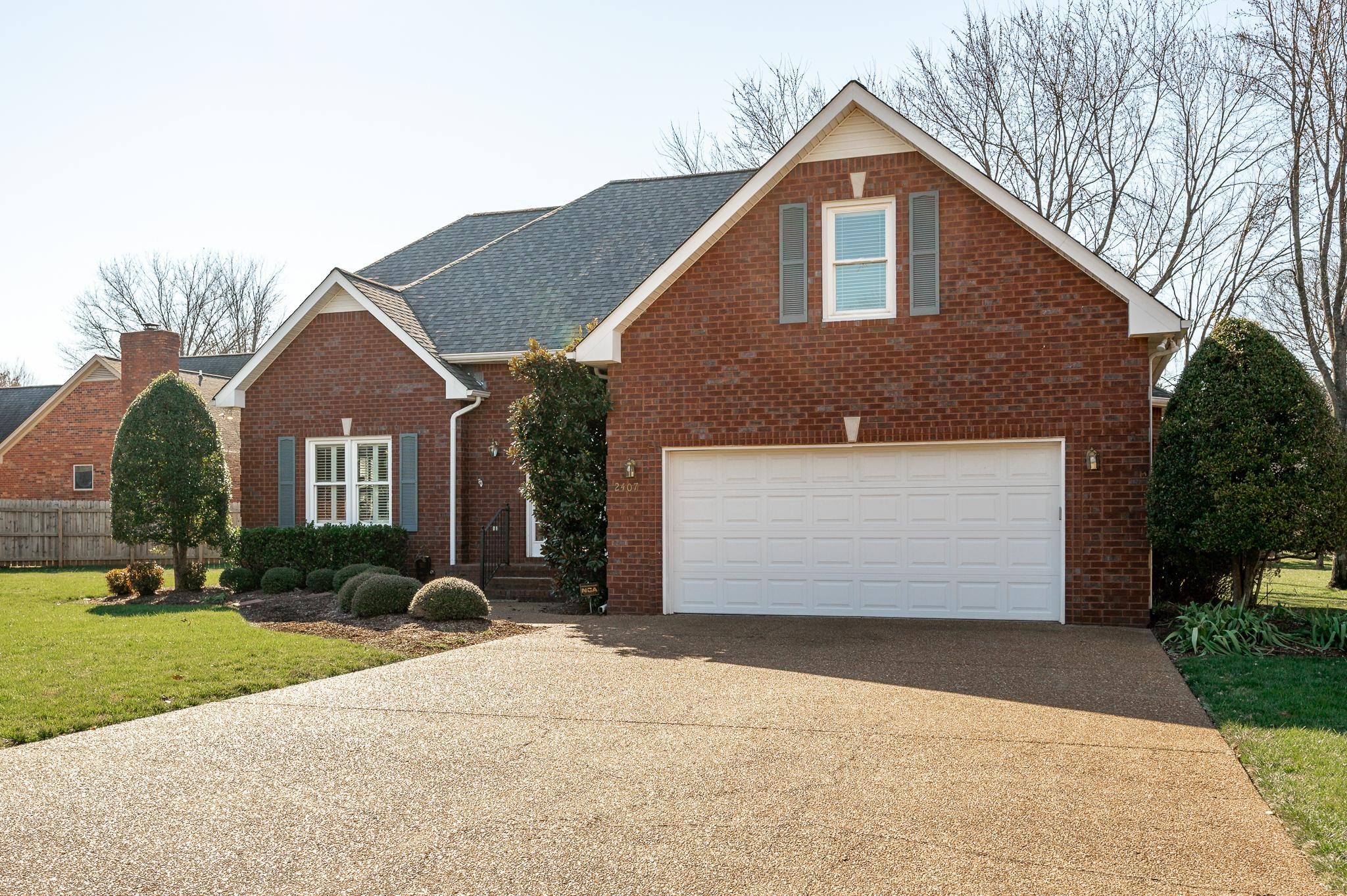 2407 Taylor Close Murfreesboro, TN 37130 - Photo 2 of 42 a front view of a house with a yard and garage