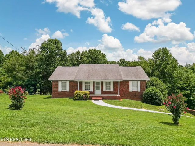 a front view of a house with a yard table and chairs