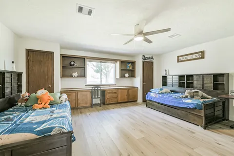 a bedroom with furniture and wooden floor