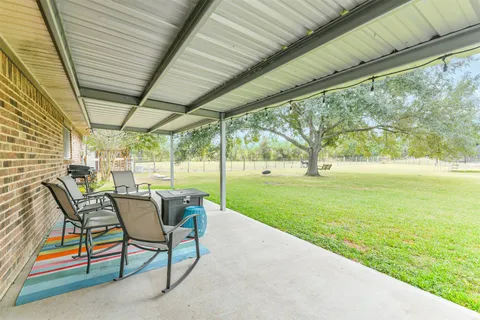 a view of yard with patio