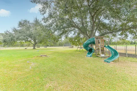 a view of a park with swings and slides