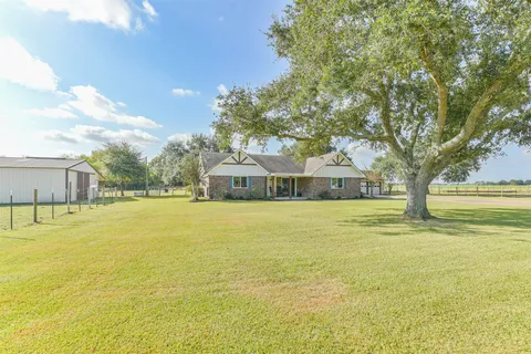 a house view with swimming pool in front of it