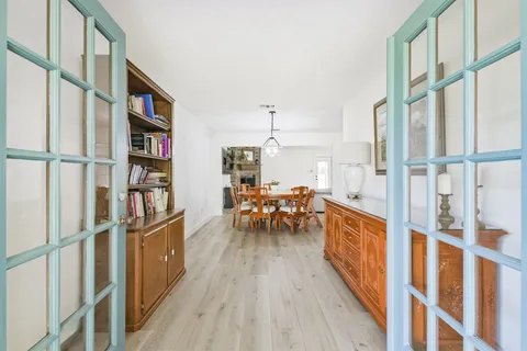 a dining room with furniture and a book shelf