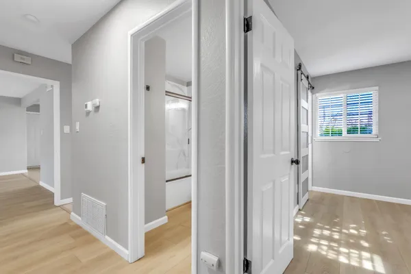 a view of a bathroom from a hallway