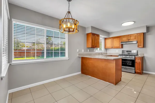 a kitchen with stainless steel appliances granite countertop a sink and a window