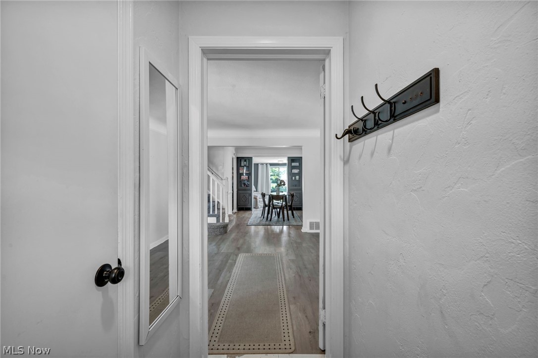 4117 Wyncote Road South Euclid, OH 44121 - Photo 25 of 50 Entryway featuring an architectural door frame, textured wall finish, and wood-finish flooring extending into the interior