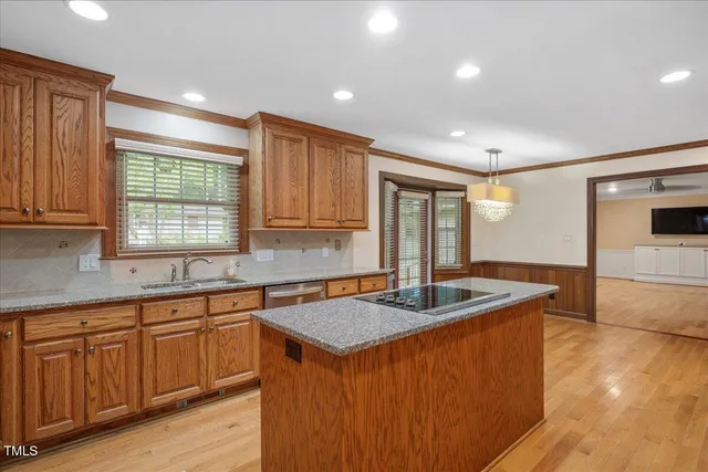 a kitchen that has a sink and a stove in it