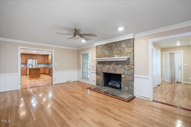 a view of empty room with wooden floor and fireplace