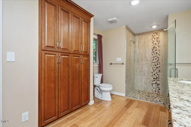 a bathroom with a toilet a sink and shower