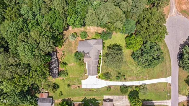 an aerial view of a house with a yard swimming pool and outdoor seating