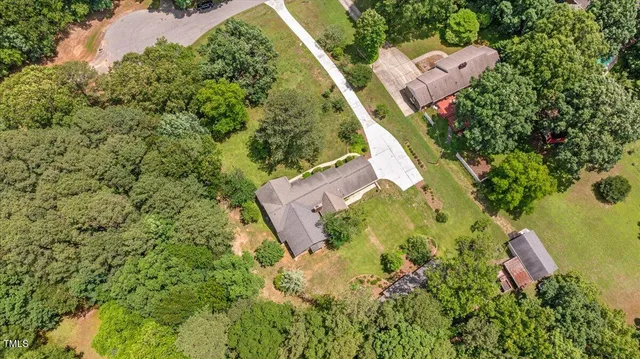 an aerial view of a house with a yard and garden