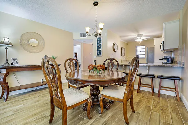 a view of a a dining room with furniture window and wooden floor
