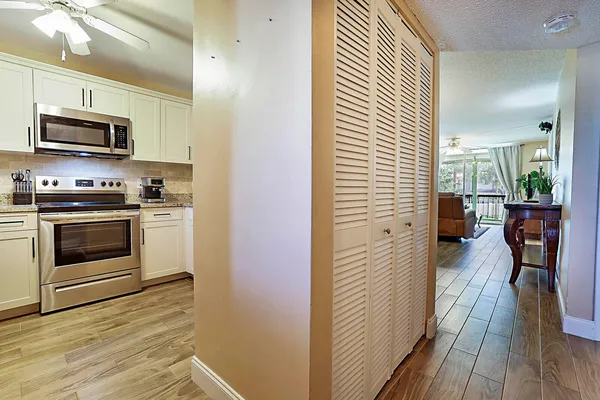 a kitchen with stainless steel appliances a stove top oven a sink and a refrigerator