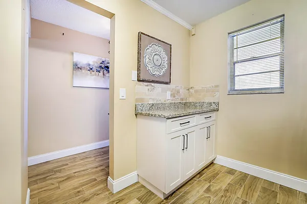 a view of kitchen cabinets and wooden floor