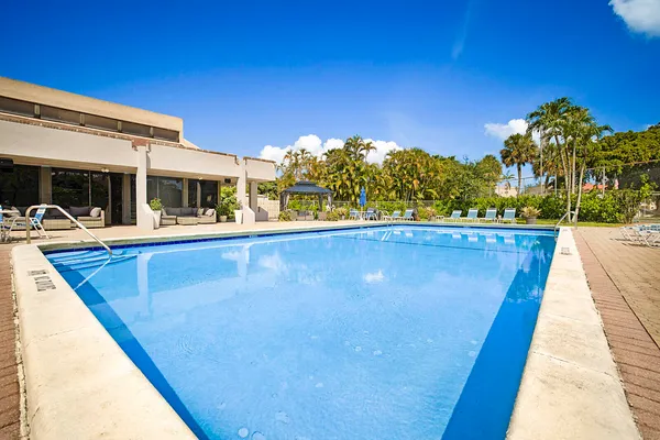 a view of a swimming pool with a lounge chairs
