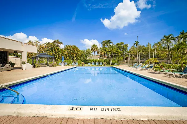 a view of a swimming pool with an outdoor seating