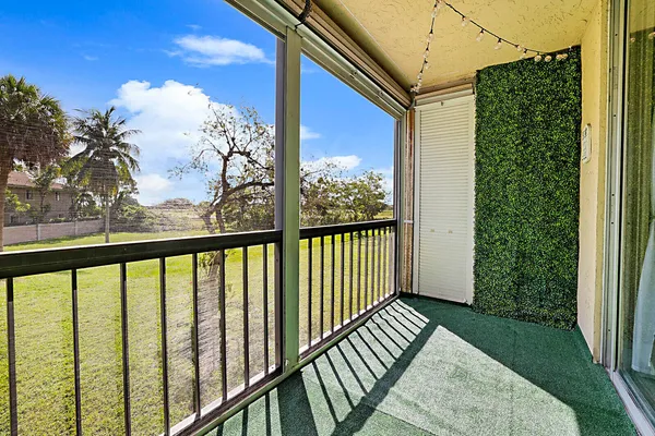 a view of a balcony with wooden floor