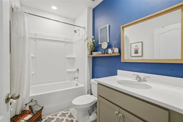 a bathroom with a sink a toilet and bathtub