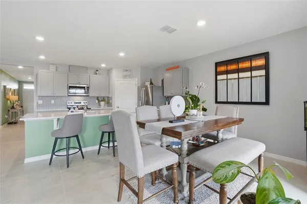 a living room with kitchen island furniture and a table