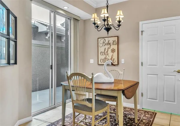 a view of a dining room with furniture and chandelier