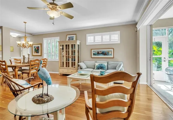 a view of a dining room with furniture wooden floor and chandelier