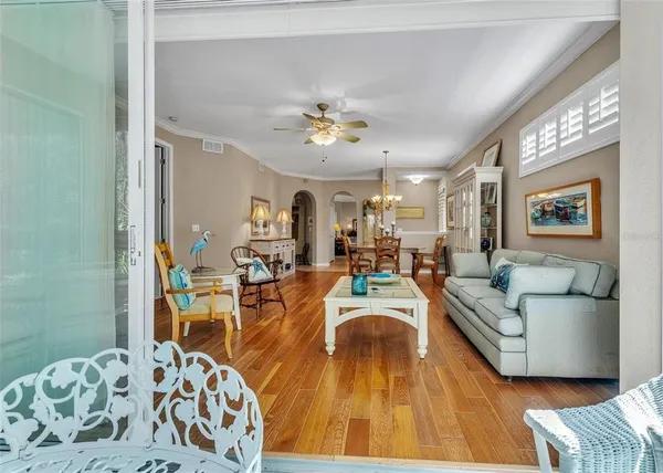 a living room with furniture and a chandelier