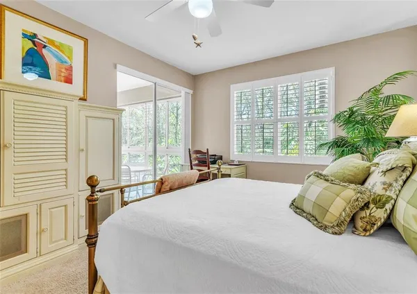 a large bed sitting in a bedroom next to a window