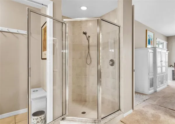 a bathroom with a shower and a glass door